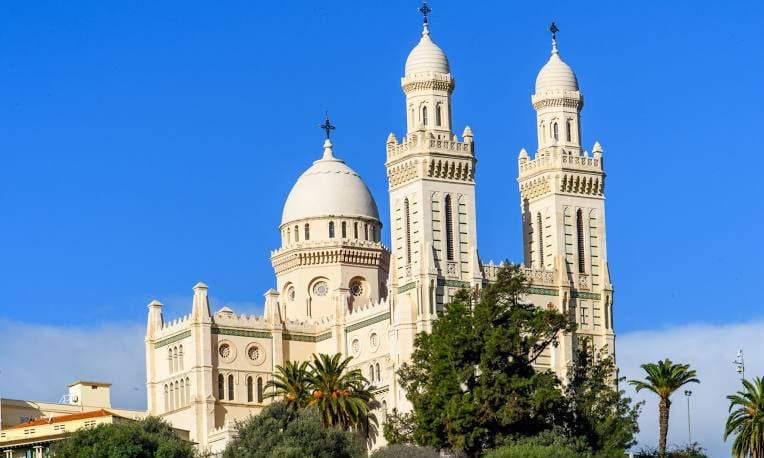 The white domes and twin towers of the Basilica of St Augustine above Annaba