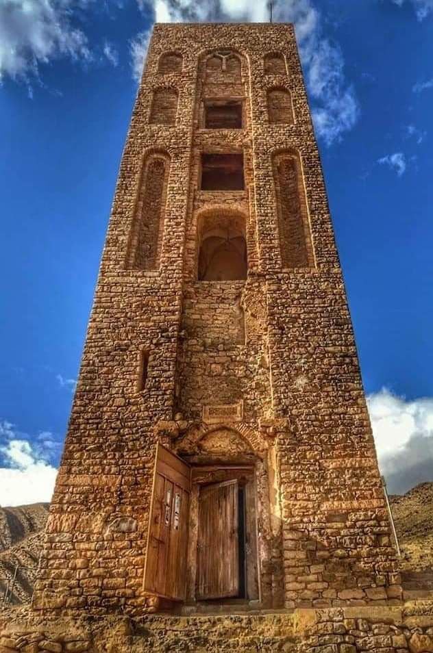 The carved niches and wooden door of the Beni Hammad minaret
