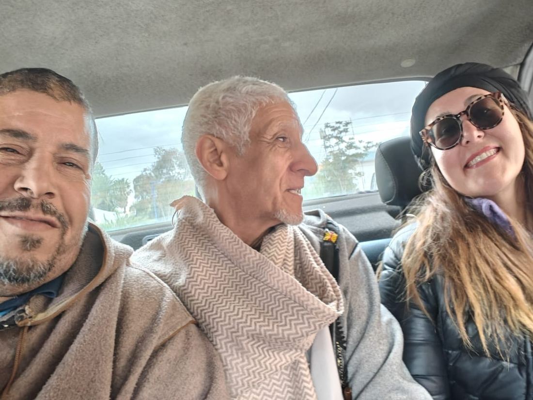 A traveller and two local guides crowded into a car selfie