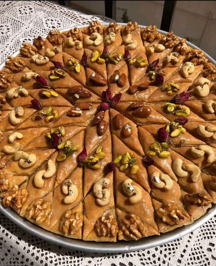 A tray of Algerian baklawa — diamonds of walnut-and-pistachio filo soaked in honey