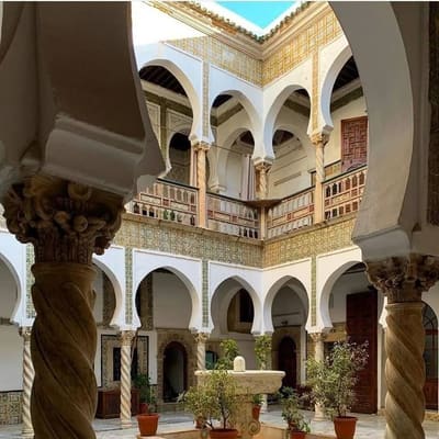 Twisted marble columns framing the courtyard fountain of an Ottoman palace in the Casbah