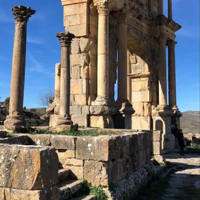 A ruined Roman monument and columns in the Aurès region