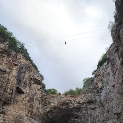 The natural rock arch of the Rhumel gorge at Constantine, a cable-car cabin crossing high above it