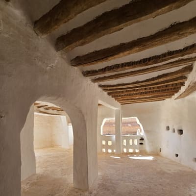 A whitewashed vaulted room in the M'Zab, roofed with palm trunks and lit through small pierced openings