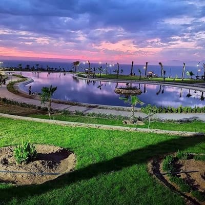 A seafront park and lagoon at sunset in Mostaganem