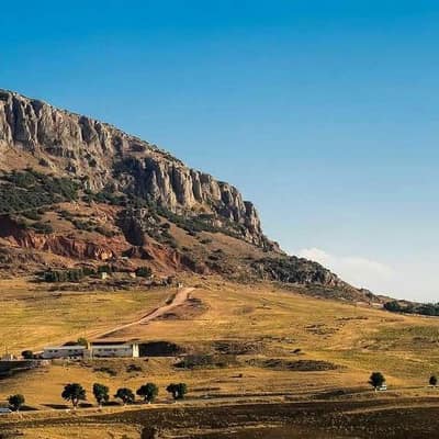 A limestone ridge above farmland in Sétif province