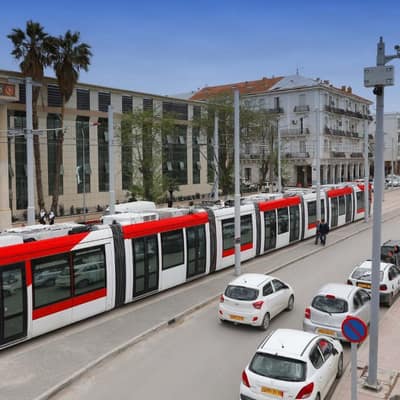 The red-and-white tram passing colonial buildings in Sétif