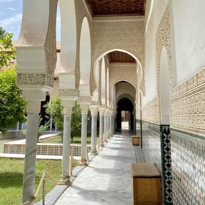 A carved stucco arcade and tiled gallery in a restored palace in Tlemcen