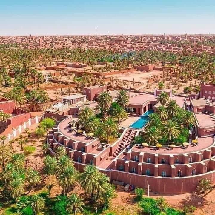 Aerial view of the red-ochre town of Timimoun and its palm belt, the Red Oasis of the Gourara