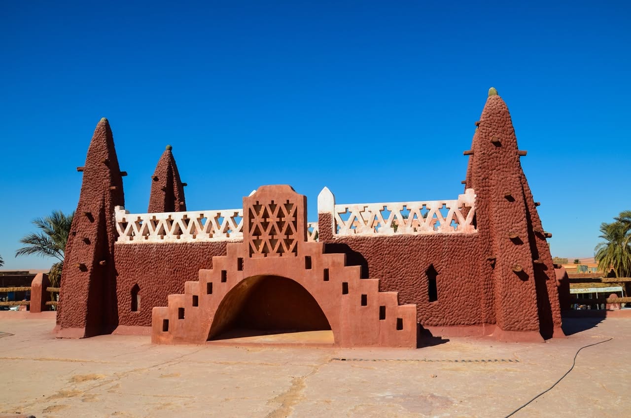 Red Sudanese-style mosque with conical pinnacles, Timimoun