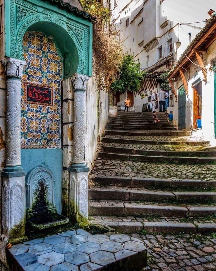 A tiled Ottoman fountain beside a stepped cobbled lane in the Casbah of Algiers