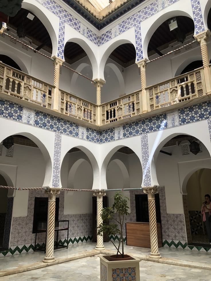 Horseshoe arches and blue-and-white tilework around an Ottoman palace courtyard in the Casbah