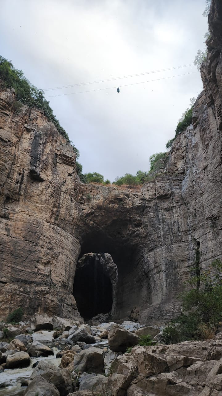The natural rock arch of the Rhumel gorge at Constantine, a cable-car cabin crossing high above it