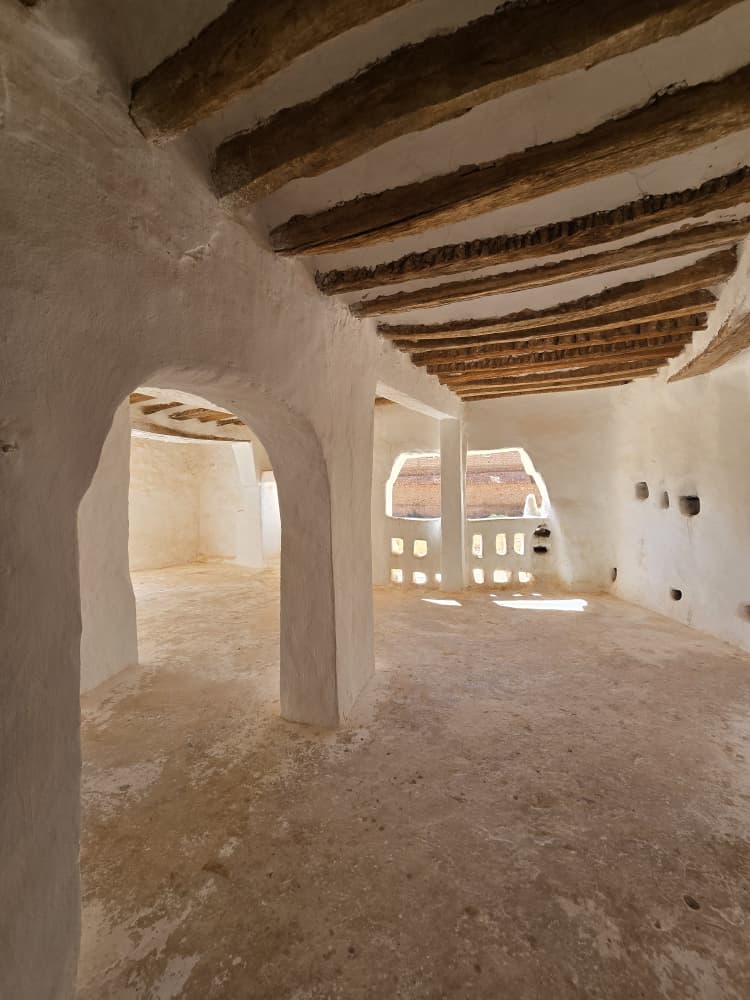 A whitewashed vaulted room in the M'Zab, roofed with palm trunks and lit through small pierced openings